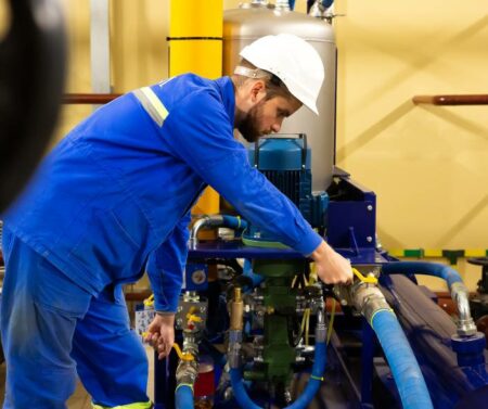 Technician conducting industrial pump repair on a high speed pump