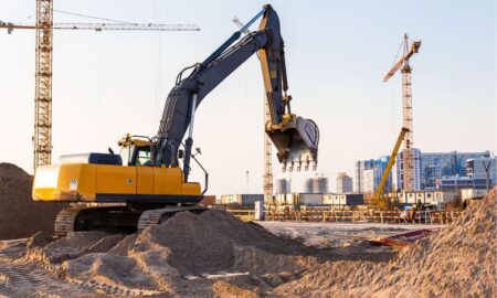backhoe on construction site serviced by Texas pump repair